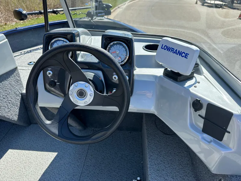 Slide: The Image of 2019 Tracker Pro Guide V-16 WT boat dashboard with steering wheel and Lowrance navigation system. - 4