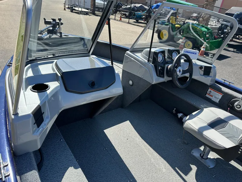 Slide: The Image of 2019 Tracker Pro Guide V-16 WT boat interior with steering console and seating. - 8
