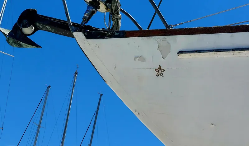 Slide: The Image of Bow of 1955 Concordia 41 Yawl sailboat against clear blue sky. - 17