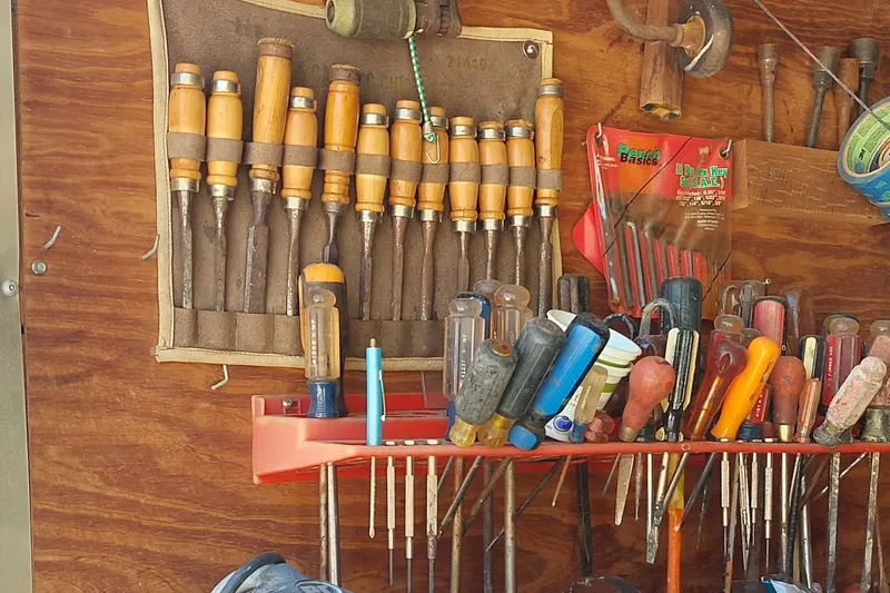 Slide: The Image of Woodworking tools neatly organized on a wall, featuring chisels and screwdrivers. - 20