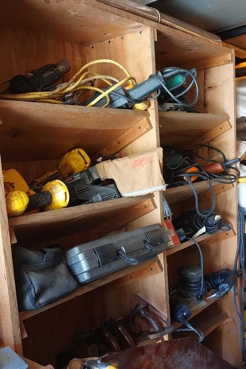 Slide: The Image of Wooden shelves filled with various power tools and equipment, Concordia 41 Yawl, 1955. - 21