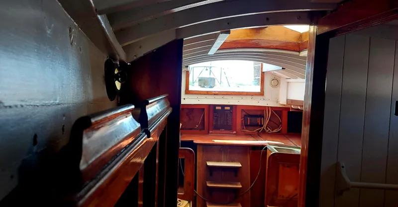 Slide: The Image of Interior of a 1955 Concordia 41 Yawl, showcasing classic wooden craftsmanship. - 4