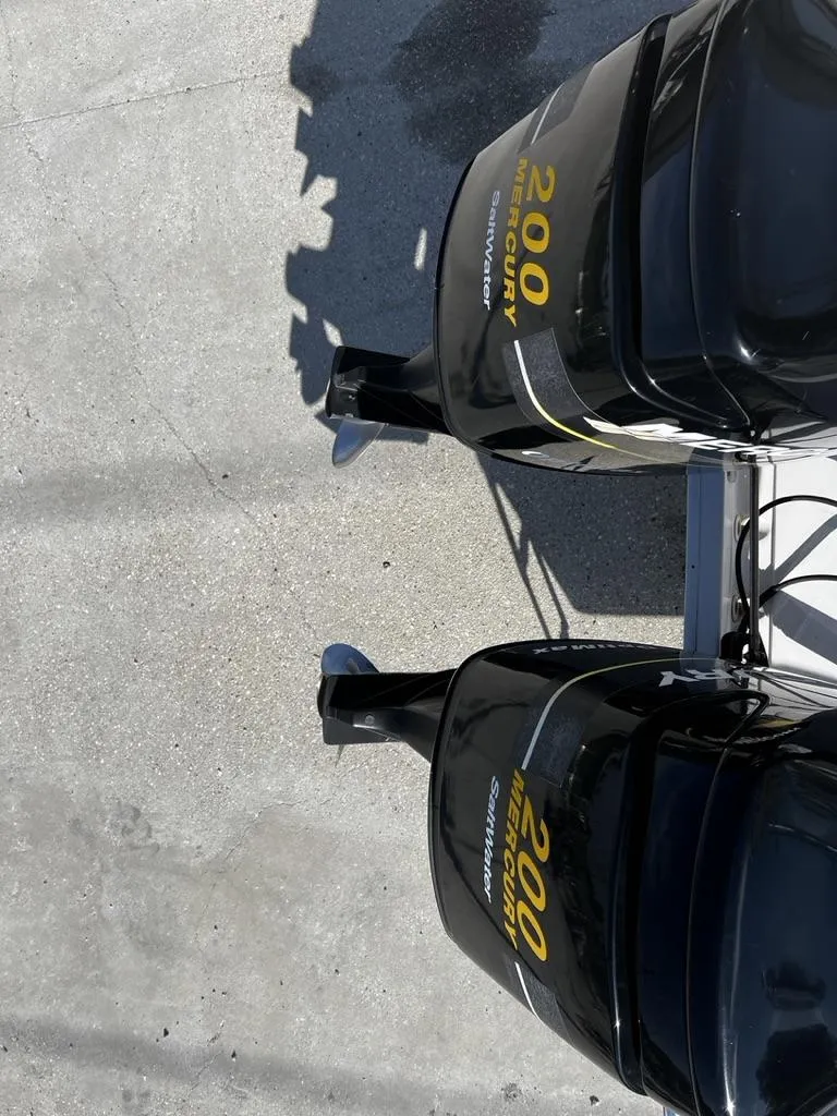 Slide: The Image of Twin Mercury 200 outboard engines on a 2001 Pro-Line 27 Express boat. - 20