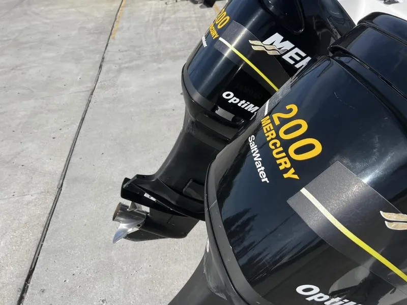 Slide: The Image of Twin Mercury 200 outboard engines on a 2001 Pro-Line 27 Express boat. - 7