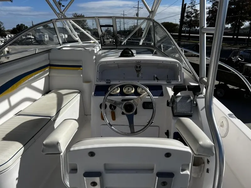 Slide: The Image of 2001 Pro-Line 27 Express boat cockpit with steering wheel and seating. - 9