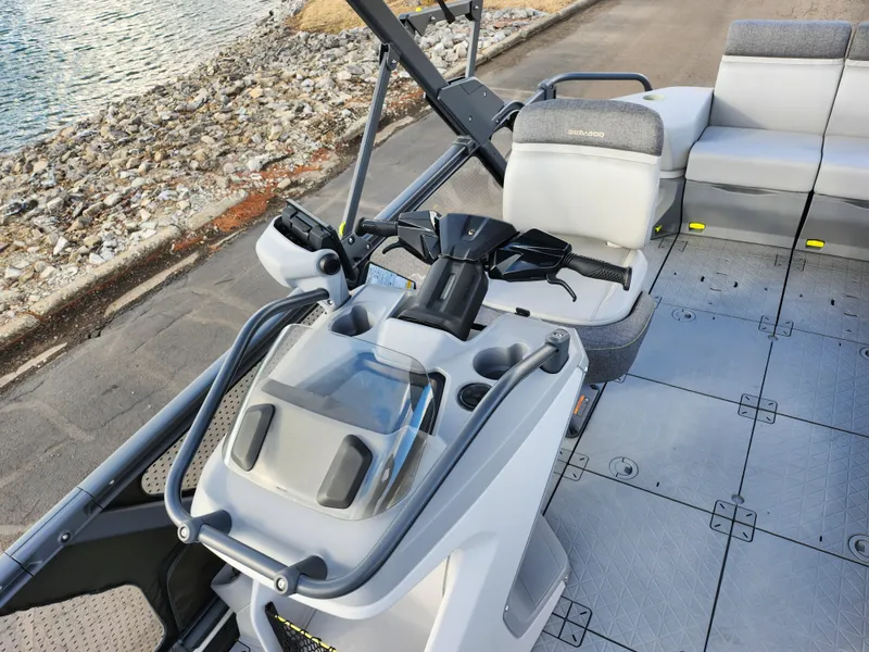 Slide: The Image of 2022 Sea-Doo Switch Sport 21 dashboard and seating area by the water. - 11