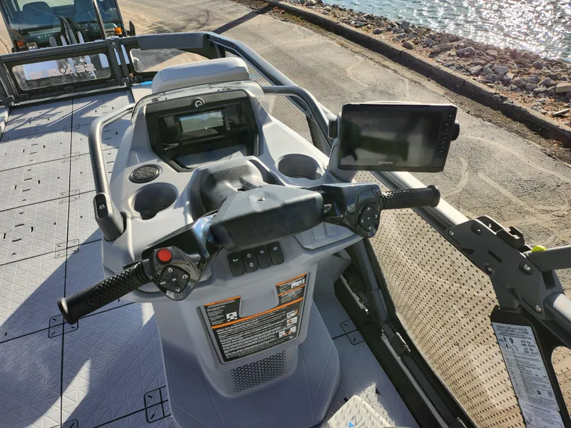 Slide: The Image of 2022 Sea-Doo Switch Sport 21 dashboard with steering wheel and digital display by the water. - 17