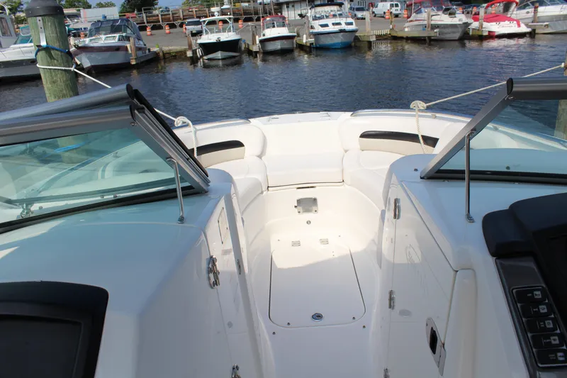 Slide: The Image of 2011 Chaparral 264 Sunesta boat interior with open bow, docked at marina. - 18