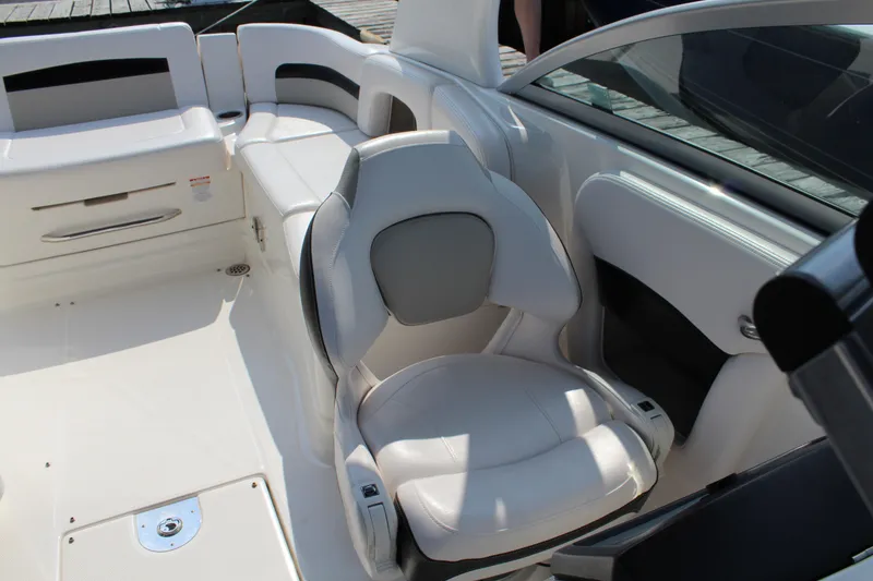 Slide: The Image of 2011 Chaparral 264 Sunesta boat interior with white seating and sleek design. - 25