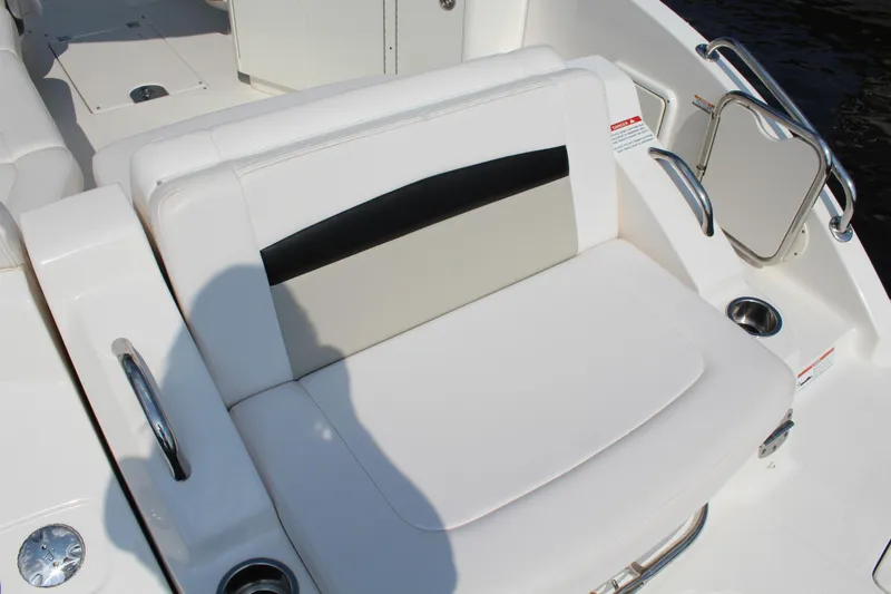 Slide: The Image of 2011 Chaparral 264 Sunesta boat interior seating with white and black upholstery. - 27