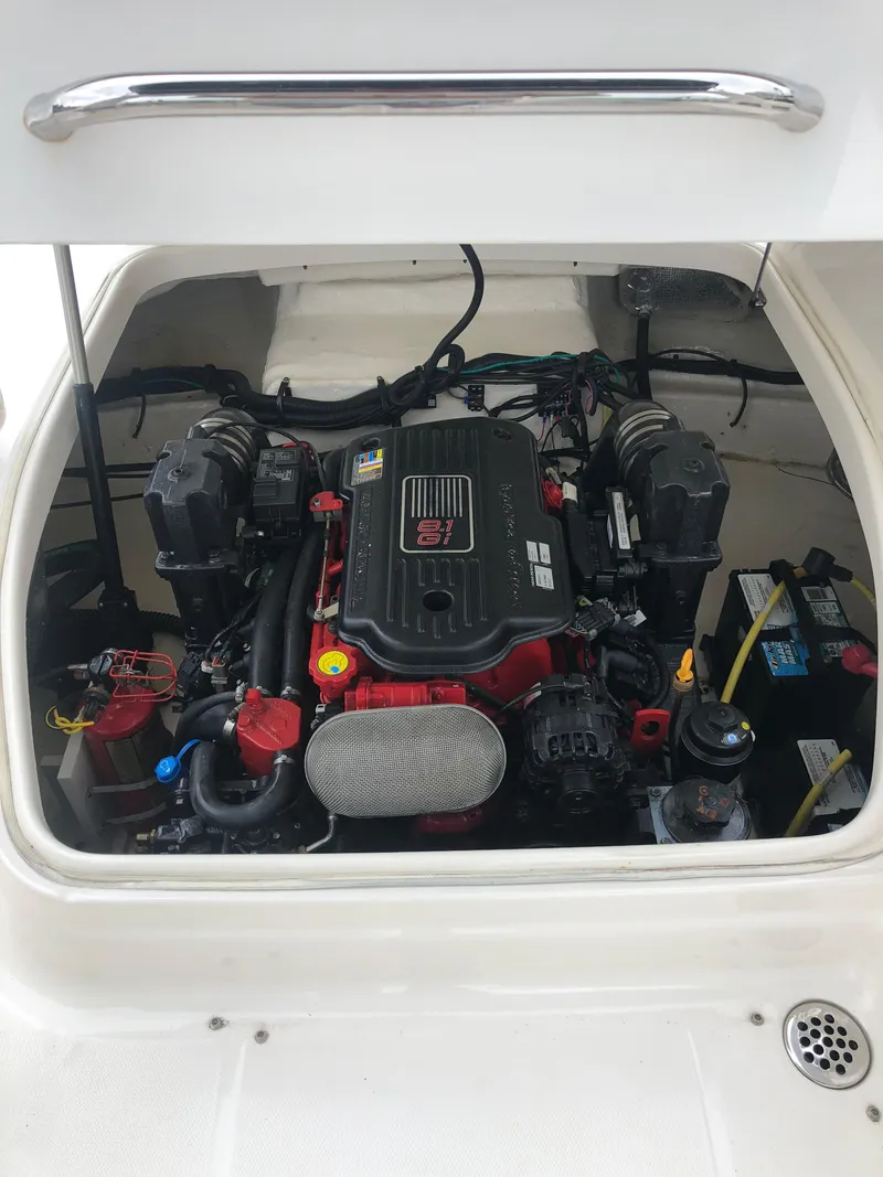 Slide: The Image of Engine compartment of 2011 Chaparral 264 Sunesta boat, showcasing detailed mechanical components. - 30