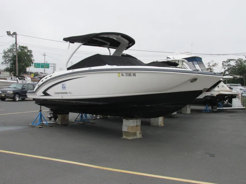 Slide: The Image of 2011 Chaparral 264 Sunesta boat on display in a parking lot. - 6