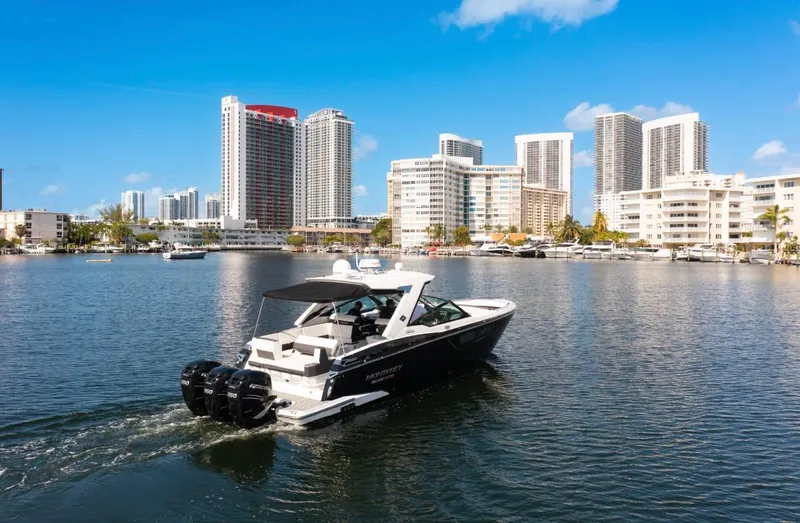Slide: The Image of Monterey 385 Super Express 2020 cruising in urban waterfront with skyscrapers. - 14