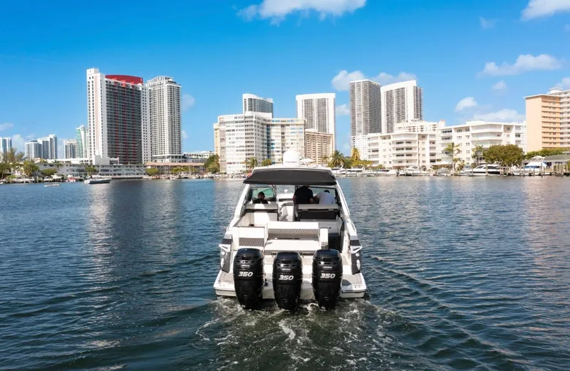 Slide: The Image of 2020 Monterey 385 Super Express boat cruising near city skyline. - 15