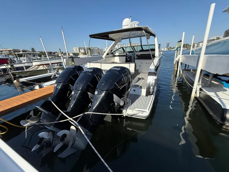 Slide: The Image of 2020 Monterey 385 Super Express boat docked with triple outboard engines. - 22
