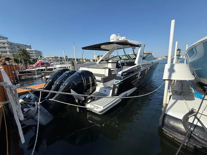 Slide: The Image of 2020 Monterey 385 Super Express boat docked with triple outboard engines. - 25