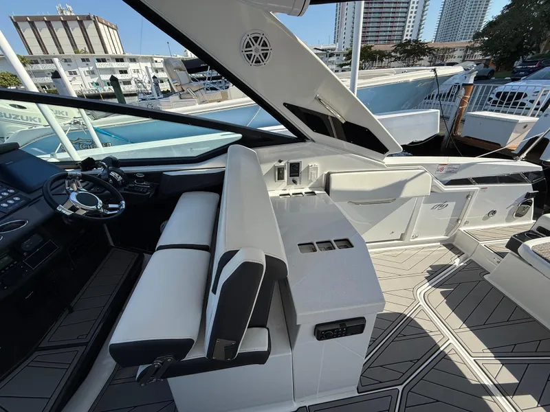 Slide: The Image of 2020 Monterey 385 Super Express yacht interior with modern seating and steering area. - 34