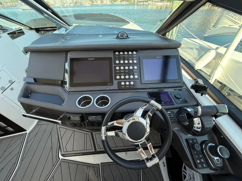 Slide: The Image of Cockpit of 2020 Monterey 385 Super Express boat with modern controls and dual screens. - 38