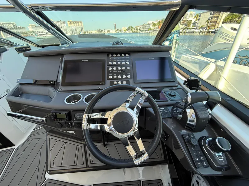 Slide: The Image of Cockpit of 2020 Monterey 385 Super Express boat with modern controls and dual screens. - 39