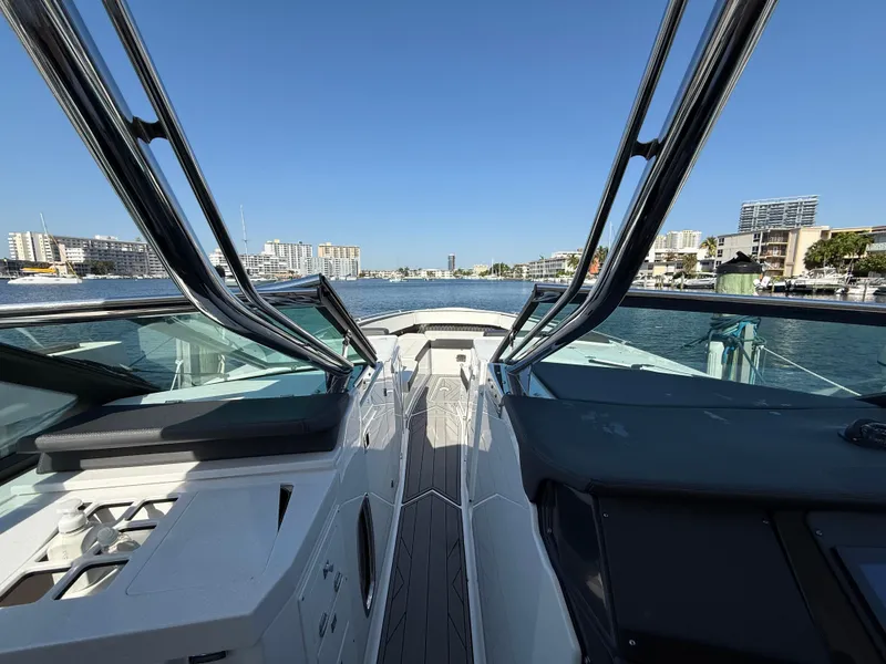 Slide: The Image of 2020 Monterey 385 Super Express yacht cruising in a sunny marina. - 45