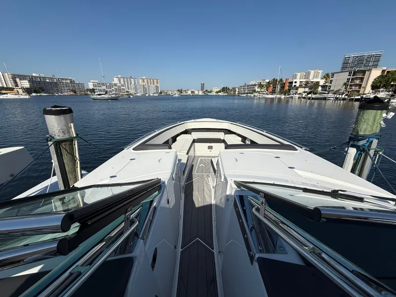 Slide: The Image of 2020 Monterey 385 Super Express yacht docked in a marina with cityscape background. - 47