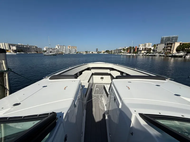 Slide: The Image of 2020 Monterey 385 Super Express yacht docked in a marina with cityscape background. - 48