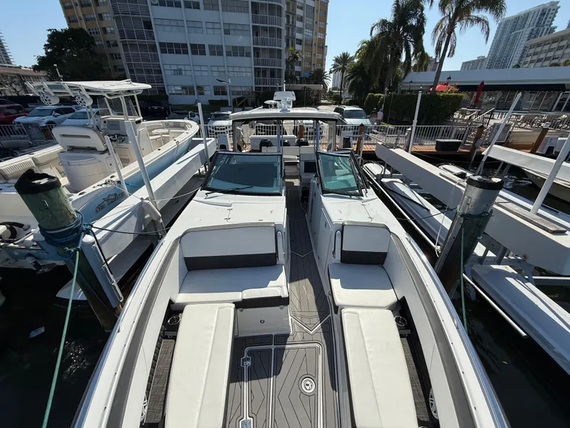 Slide: The Image of 2020 Monterey 385 Super Express boat docked, featuring spacious seating and sleek design. - 50