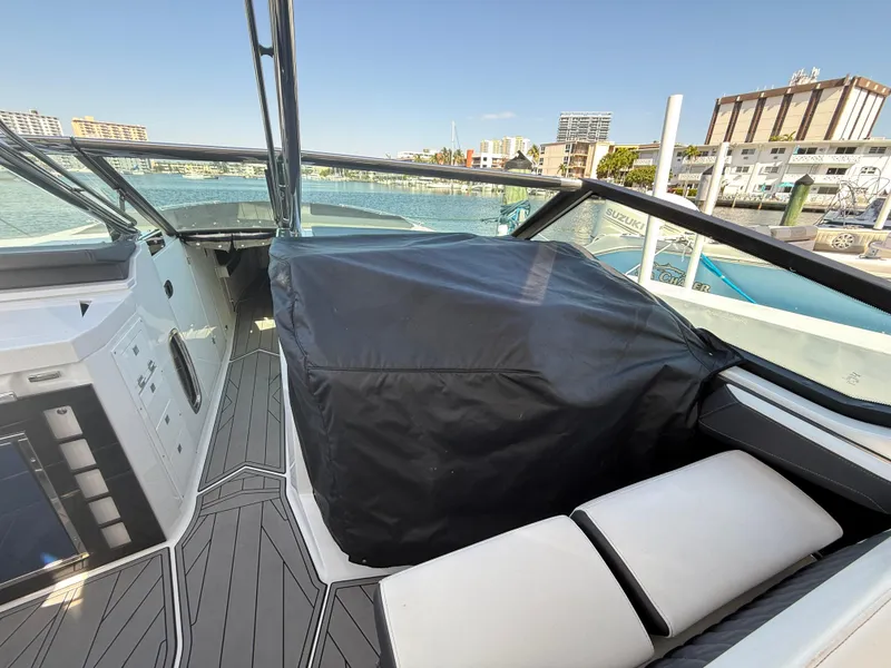 Slide: The Image of 2020 Monterey 385 Super Express boat interior with covered seating, docked at marina. - 54