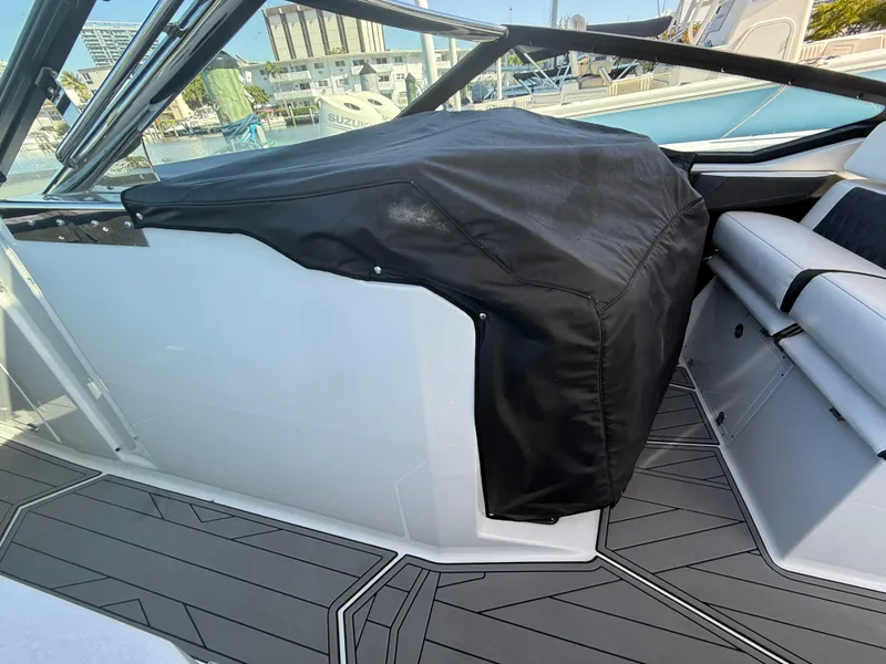 Slide: The Image of 2020 Monterey 385 Super Express boat interior with covered dashboard and sleek seating. - 55