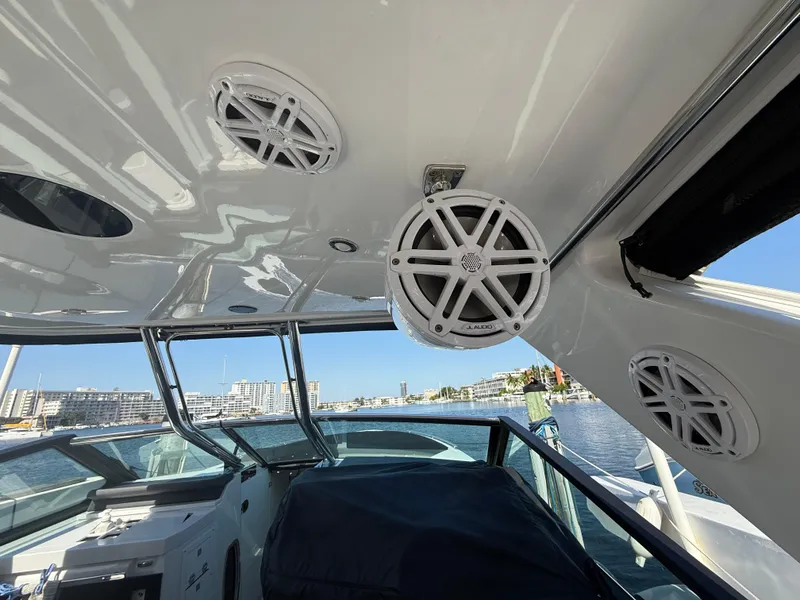 Slide: The Image of 2020 Monterey 385 Super Express boat interior with speakers and waterfront view. - 57