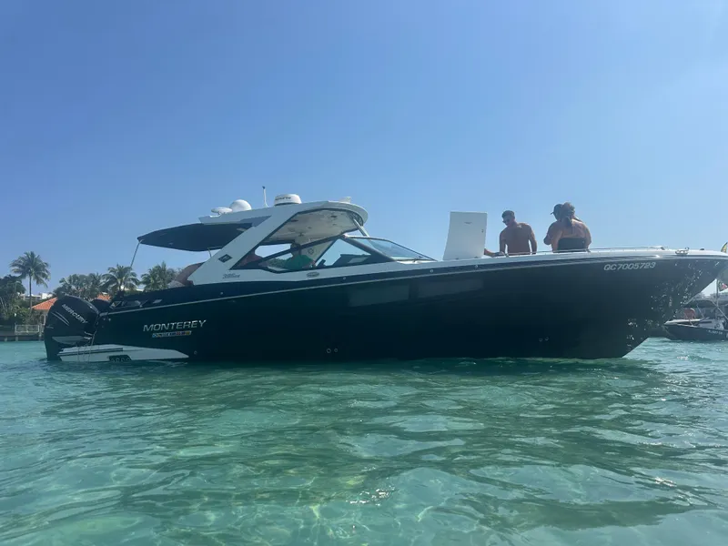 Slide: The Image of 2020 Monterey 385 Super Express boat on clear water with people onboard. - 67