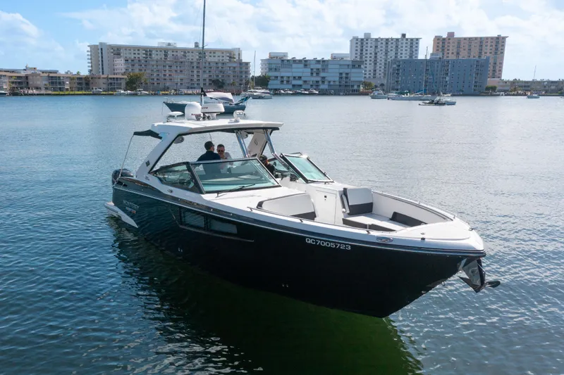 Slide: The Image of 2020 Monterey 385 Super Express boat on calm water with cityscape background. - 8