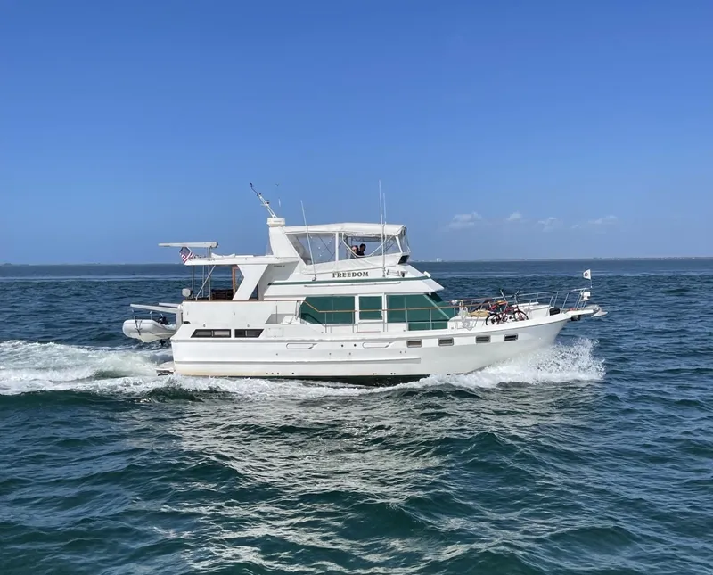 Slide: The Image of 1989 CHB Oceania 42 yacht cruising on open water under clear blue skies. - 1