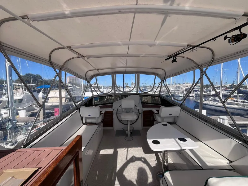 Slide: The Image of Flybridge of 1989 CHB Oceania 42 yacht with seating and helm, docked at marina. - 11