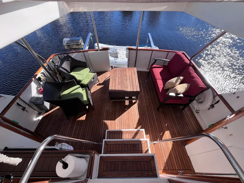 Slide: The Image of Spacious deck of 1989 CHB Oceania 42 yacht with seating and table, overlooking water. - 17