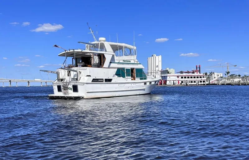 Slide: The Image of 1989 CHB Oceania 42 yacht on water with cityscape and blue sky background. - 2