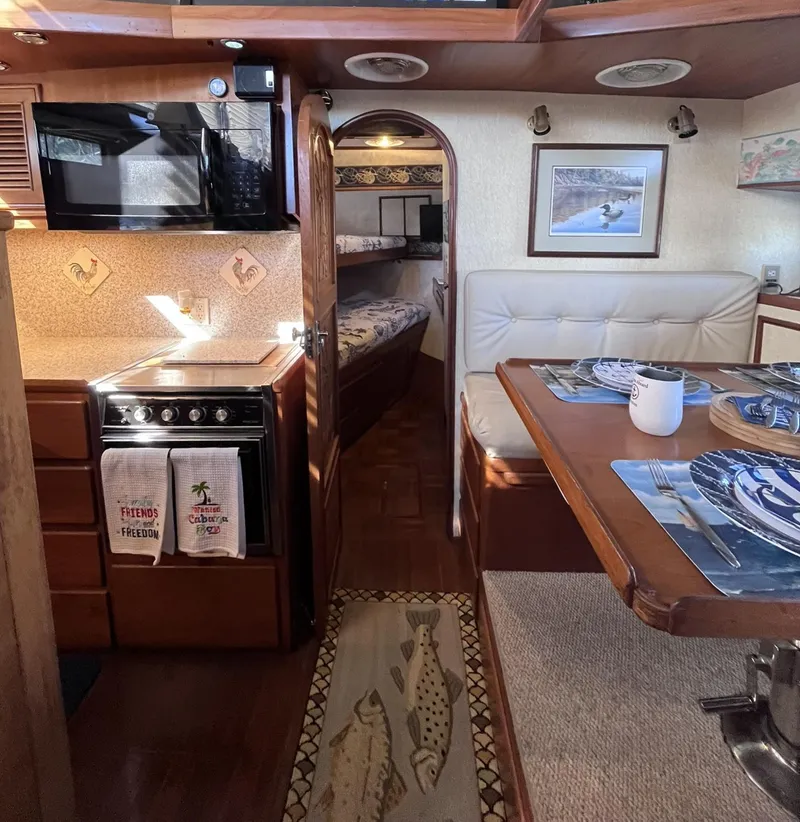 Slide: The Image of Interior of 1989 CHB Oceania 42 yacht with kitchen, dining area, and cozy cabin. - 23