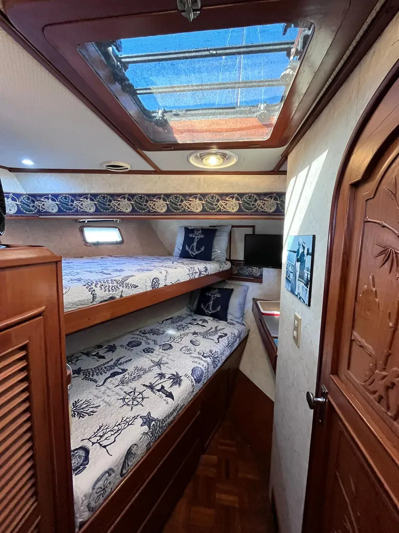 Slide: The Image of Cozy cabin interior of 1989 CHB Oceania 42 with nautical-themed bunk beds. - 24