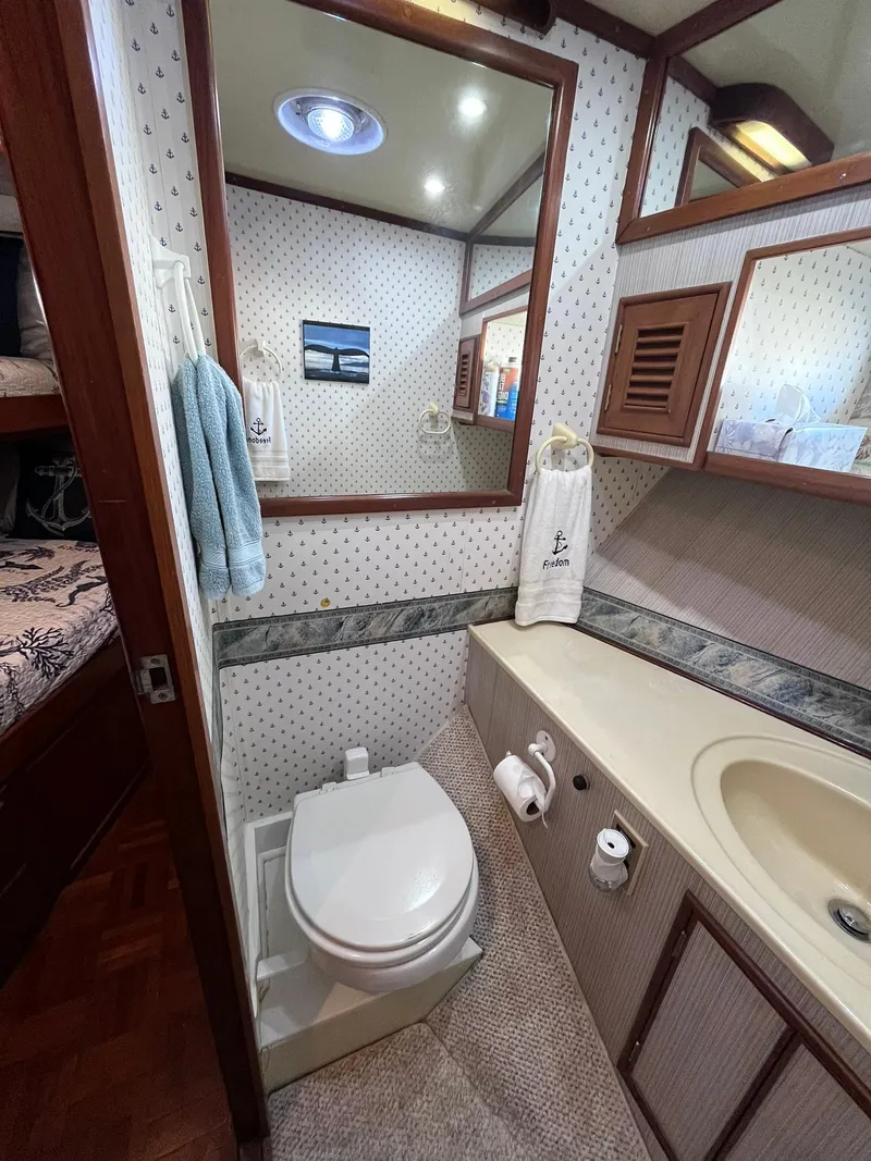 Slide: The Image of Bathroom interior of 1989 CHB Oceania 42 yacht with toilet, sink, and mirror. - 25