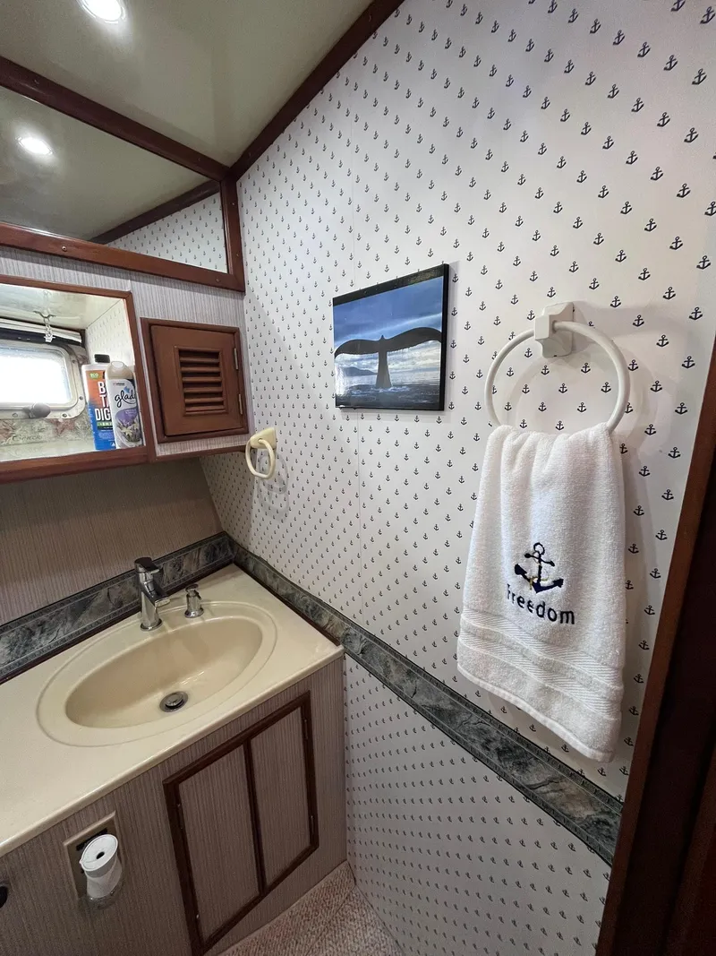 Slide: The Image of Bathroom interior of 1989 CHB Oceania 42 yacht with nautical decor and towel. - 26