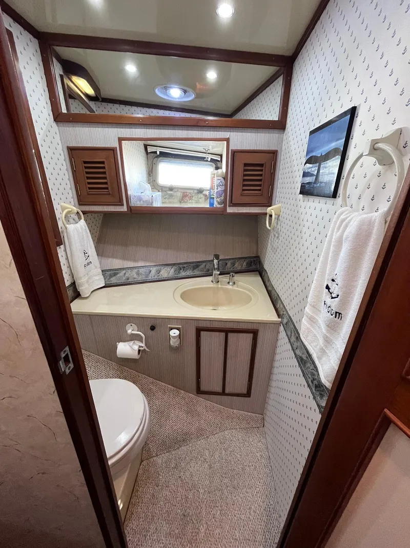 Slide: The Image of 1989 CHB Oceania 42 yacht bathroom with sink, mirror, and toilet. - 27