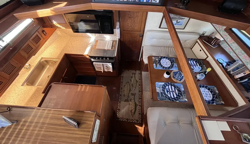 Slide: The Image of Interior of 1989 CHB Oceania 42 yacht with kitchen and dining area. - 28
