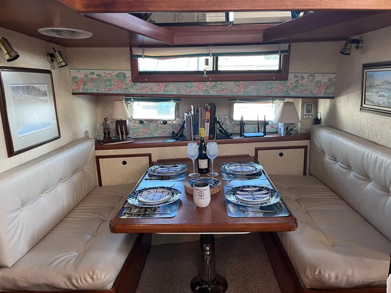 Slide: The Image of Luxurious dining area in a 1989 CHB Oceania 42 yacht, featuring elegant table settings. - 29