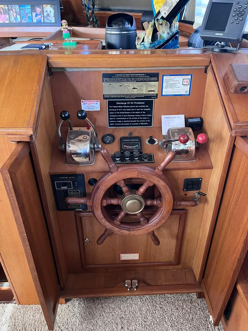 Slide: The Image of Wooden helm station of 1989 CHB Oceania 42 boat with controls and navigation equipment. - 36