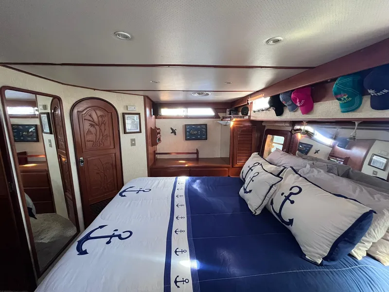 Slide: The Image of Luxurious cabin interior of 1989 CHB Oceania 42 yacht with nautical-themed bedding. - 39