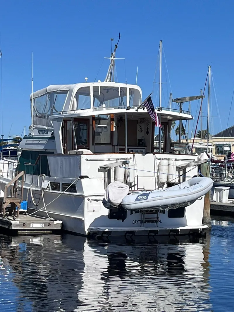 Slide: The Image of 1989 CHB Oceania 42 yacht docked at marina with inflatable boat on stern. - 4