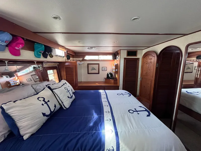 Slide: The Image of Cozy bedroom in 1989 CHB Oceania 42 yacht with nautical-themed bedding and wooden accents. - 40