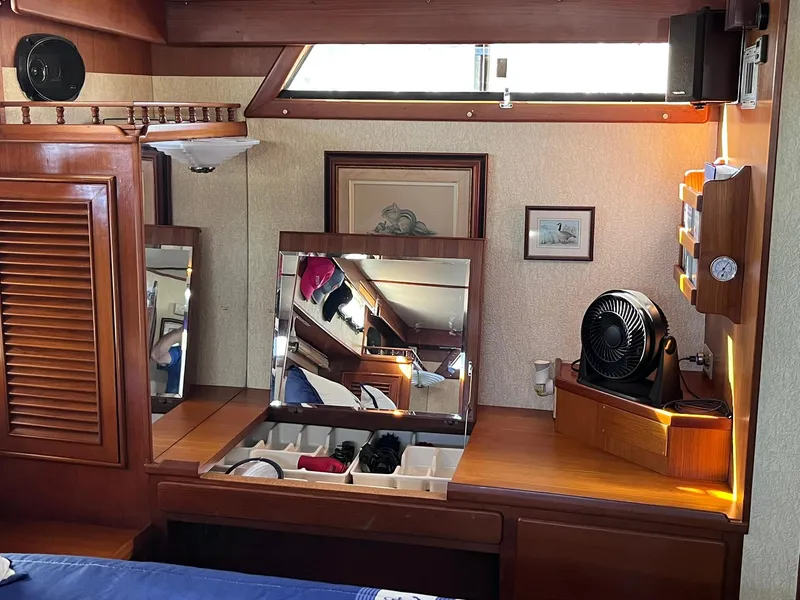 Slide: The Image of 1989 CHB Oceania 42 yacht interior with wooden cabinetry, mirrors, and storage compartments. - 41