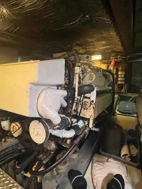 Slide: The Image of Engine room of 1989 CHB Oceania 42 boat, showcasing mechanical components and piping. - 49