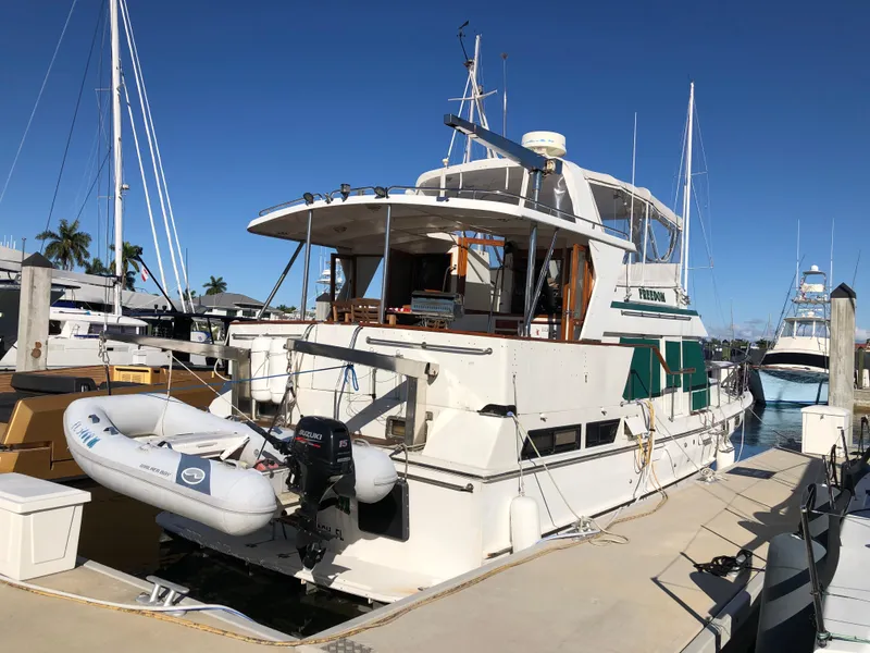 Slide: The Image of 1989 CHB Oceania 42 yacht docked at marina with inflatable dinghy attached. - 7